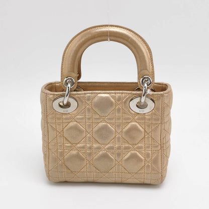 Sold Lady Dior Mini Gold Textile Cannage handbag with strap