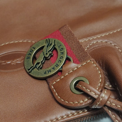 Sac de voyage Longchamp Au Sultan en cuir marron avec poignée et bandoulière en toile