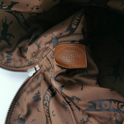 Sac de voyage Longchamp Au Sultan en cuir marron avec poignée et bandoulière en toile
