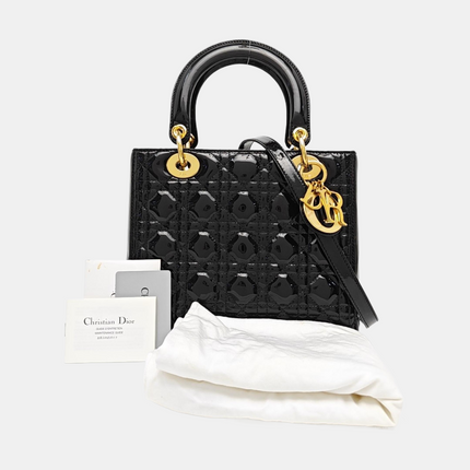 Sac à main Lady Dior moyen en cuir verni noir avec quincaillerie dorée vendu