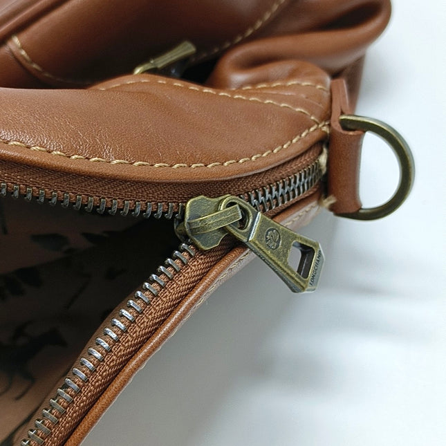 Sac de voyage Longchamp Au Sultan en cuir marron avec poignée et bandoulière en toile