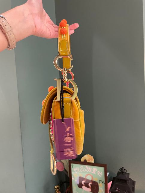 Sold Limited Edition John Galliano era Dior Saddle bag with pompom and bead