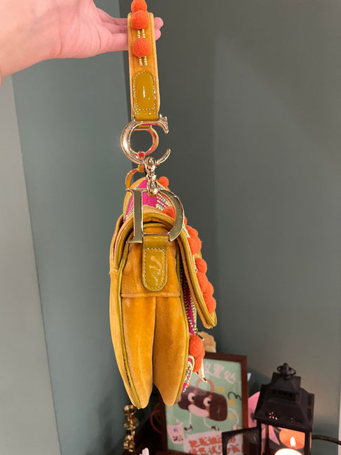 Sold Limited Edition John Galliano era Dior Saddle bag with pompom and bead